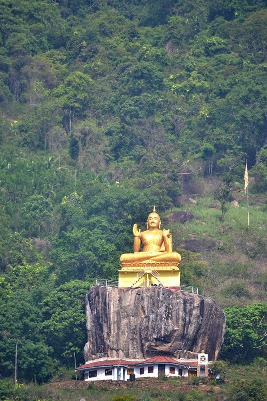The seated Buddha above the temple, seen from the Matale road. Most people photograph this and drive on.